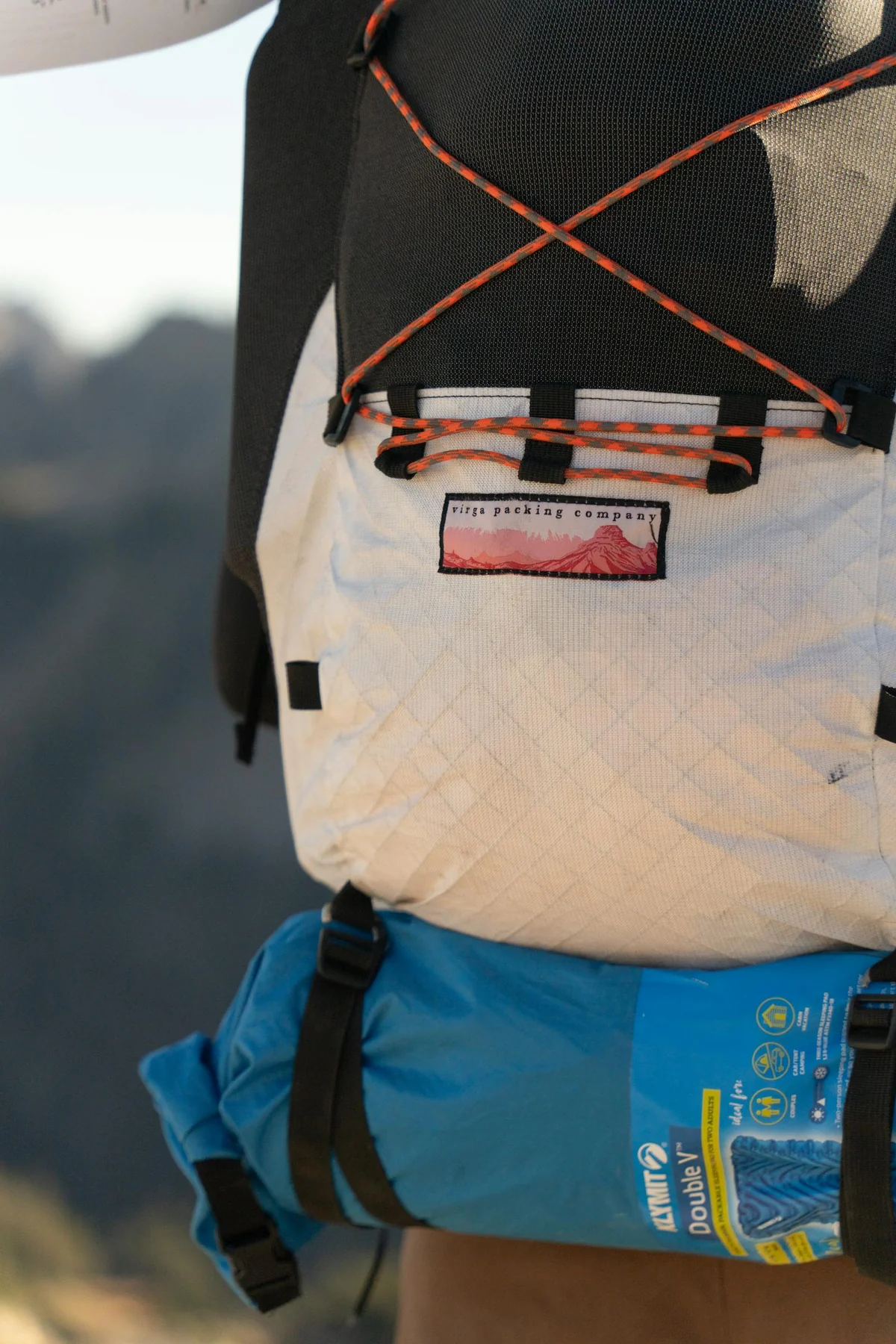 Mochila de sobrevivência com equipamento exposto: lanterna, multiferramenta, água, comida, kit de primeiros socorros